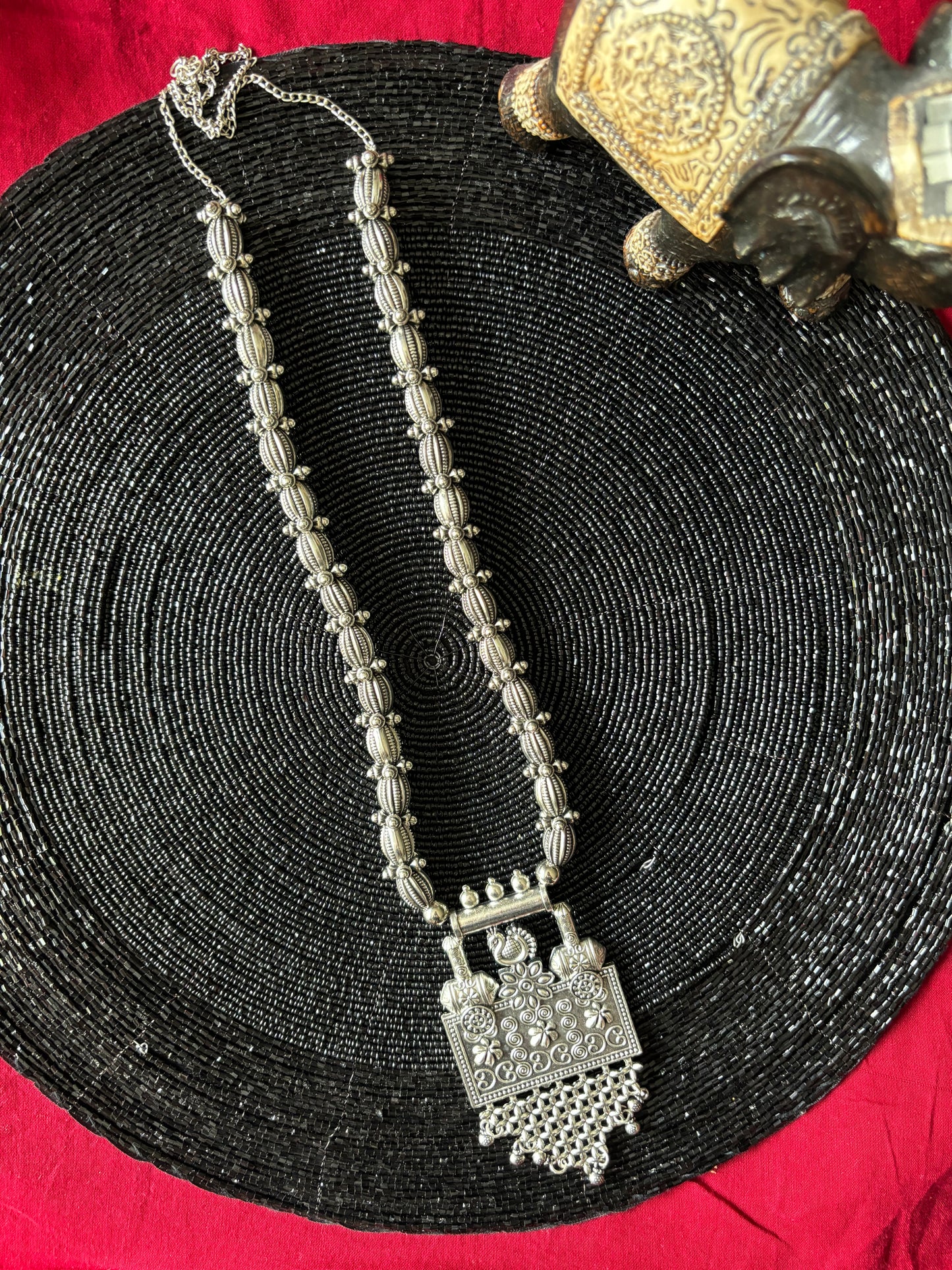 Long oxidized necklace with mini peacock